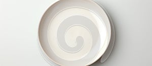 A white porcelain plate rests on a white serveware surface