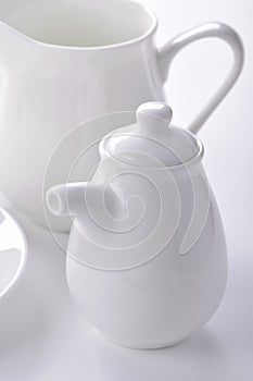 White porcelain sauceboat and creamer close-up