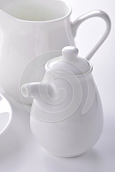 White porcelain sauceboat and creamer close-up photo