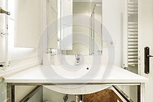 White porcelain sink on stainless steel metal structure with frameless