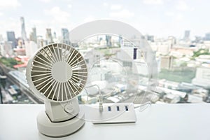 White portable USB desktop fan on office table with USB hub for battery