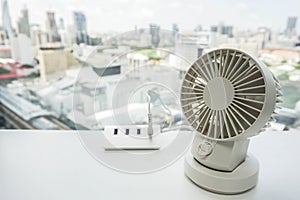 White portable USB desktop fan with USB hub in office