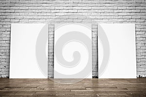 White posters on brick wall and wood floor