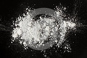 white powder on black background, flour sprinkled