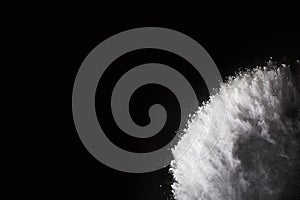 White powder explosion on black background.