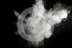 White powder explosion on black background.Stopping the movement of white powder on dark background.