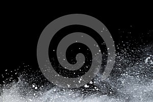 White powder explosion on black background.