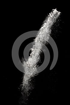 White dust particles splashing. Freez motion of talcum powder burst in dark background photo