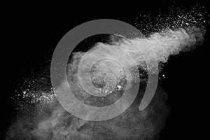 White powder explosion clouds.Freeze motion of white dust particles splash on black background