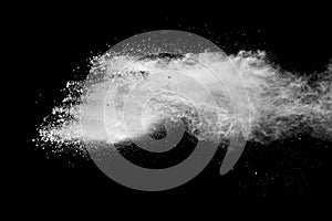 White powder explosion clouds.Freeze motion of white dust particles on black background