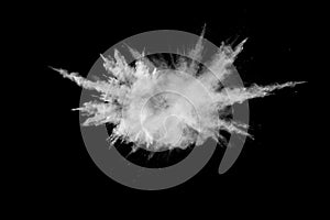 White powder explosion.Freeze motion of white dust particles on black background