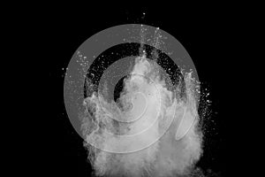 White powder explosion.Freeze motion of white dust particles on black background