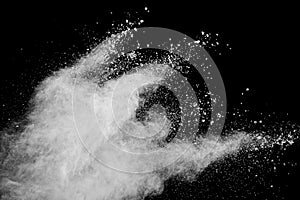 White powder explosion.Freeze motion of white dust particles on black background