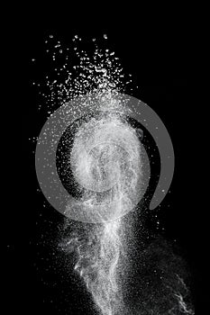 White powder explosion isolated on black