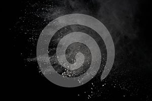 White powder explosion isolated on black background.