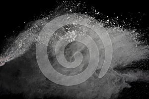 White powder explosion isolated on black background.