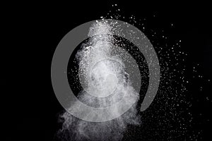 White powder explosion isolated on black background