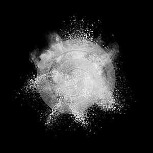 White powder explosion isolated on black photo
