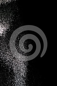 White powder splash isolated on black background. Flour sifting on a black background. Explosive powder white flour