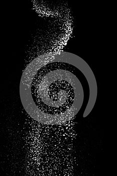 White powder splash isolated on black background. Flour sifting on a black background. Explosive powder white flour