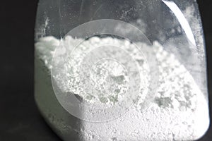 White powder in transparent jar. white powder on the table