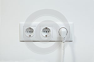 White power plug plugged in a electric socket