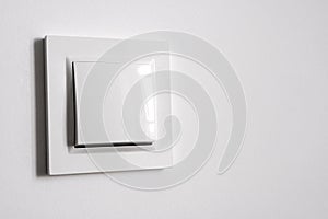 White power switch on white wall