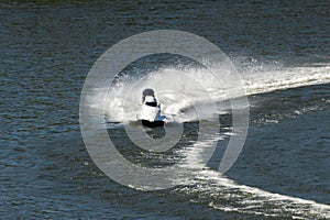 White Powerboat Making Turn on Water