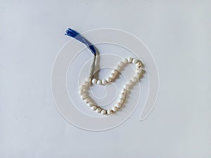 A white prayer beads on a white background which Moslems usually use for dhikr.