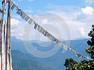 White prayer flags over a clear blue sky in India