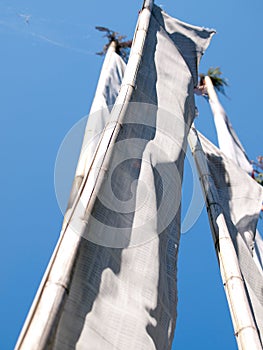 White prayer flags over a clear blue sky in India