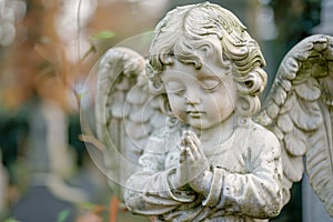 White praying angel child statue at cemetery