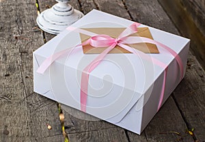 White present box with pink knot