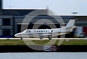 White private corporate jet taking off