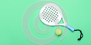 White professional paddle tennis racket and ball on mint color background. Horizontal sport theme poster, greeting cards, headers,