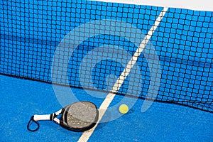 White professional paddle tennis racket with natural lighting on blue background. Horizontal sport theme poster