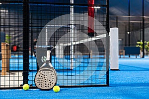 White professional paddle tennis racket with natural lighting on blue background. Horizontal sport theme poster