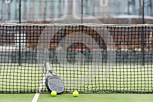 White professional paddle tennis racket with natural lighting on blue background. Horizontal sport theme poster