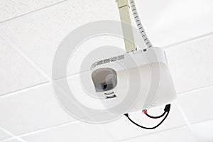 White projector hanging on the ceiling
