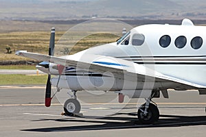 White prop plane parked photo