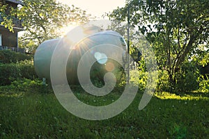 White propane storage tank in yard