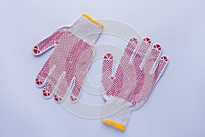 White protective gloves with red circles.