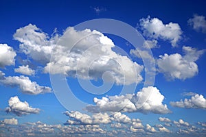 White puffy clouds in blue sky photo