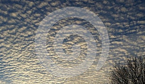 White puffy clouds and blue sky before sunset