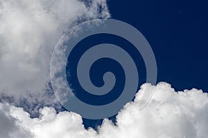 White puffy clouds in a pure blue sky