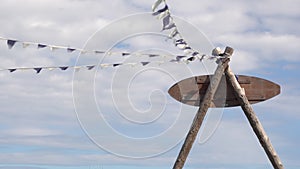 White - purple fluttering in the wind. Footage. Blue sky with clouds. Hanging garlands. White - purple flags in the air