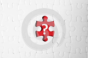 White puzzle with missing piece and question mark on background, top view