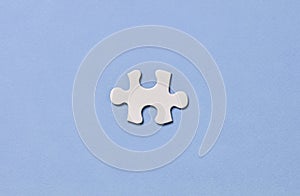 White puzzle piece on blue background