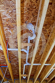 White PVS pipeline under white ceiling in the new building. construction industry pipeline for drainage system