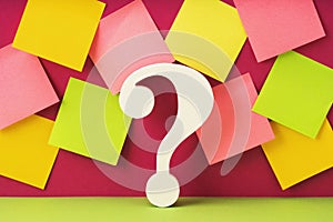 White question mark symbol against many mockup notes background